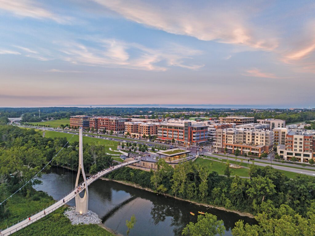 A white bridge stretching over a river, part of the Bridge Park real estate development. 