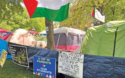 Palestinian flags hanging above an encampment on the U-M Diag.