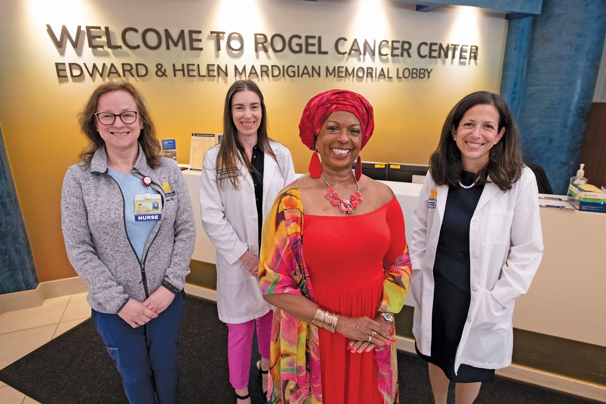 Four women standing in a hospital lobby. 