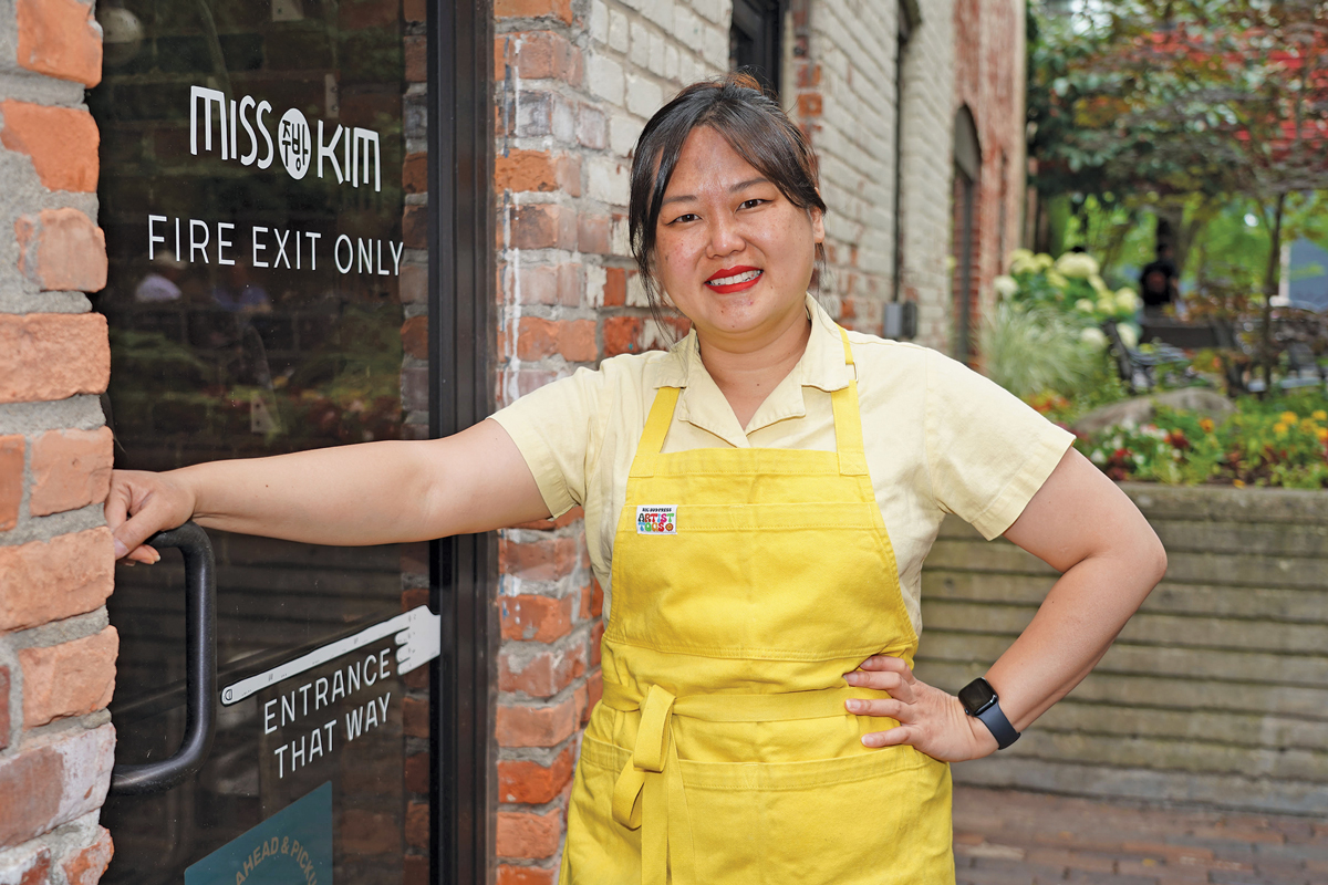 A woman standing outside a restaurant.