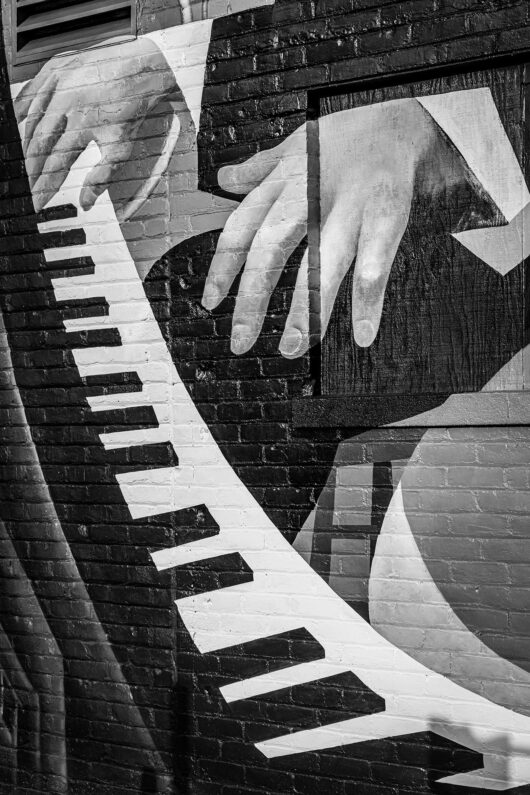 A mural of hands playing a piano.