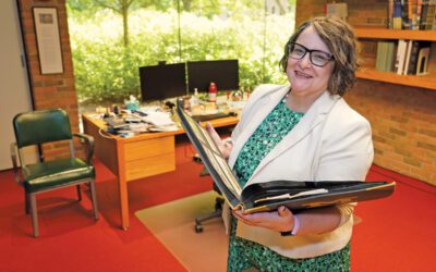 Alexis Antracoli holding a book in her office