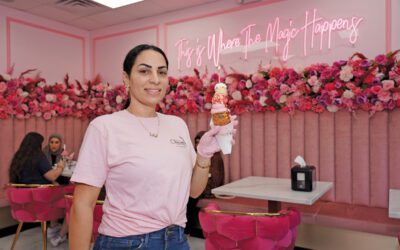 Amanda Debek holding a chimney cake in House of Chimney Cakes Café.