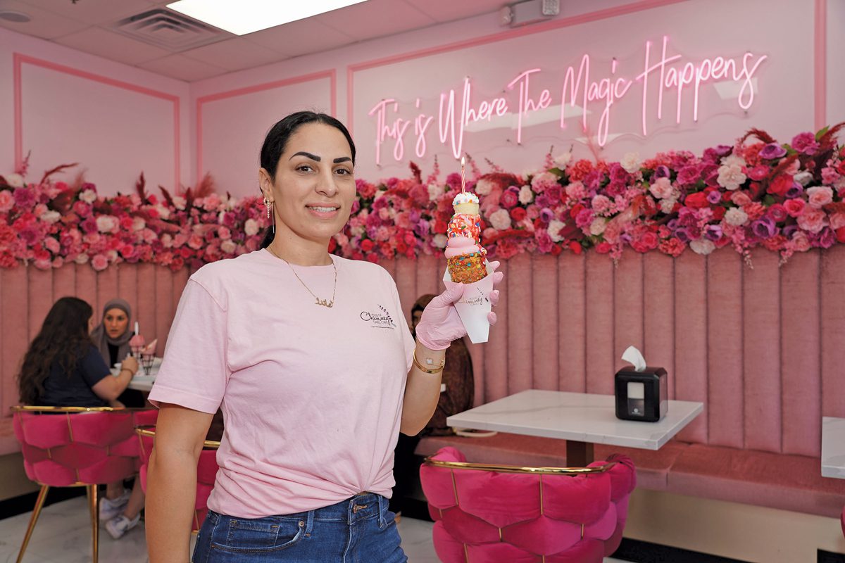 Amanda Debek holding a chimney cake in House of Chimney Cakes Café.