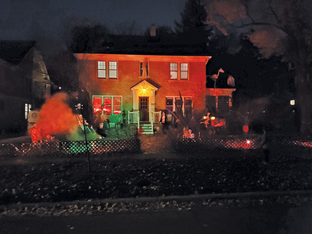 Exterior of a house lit up for Halloween. 