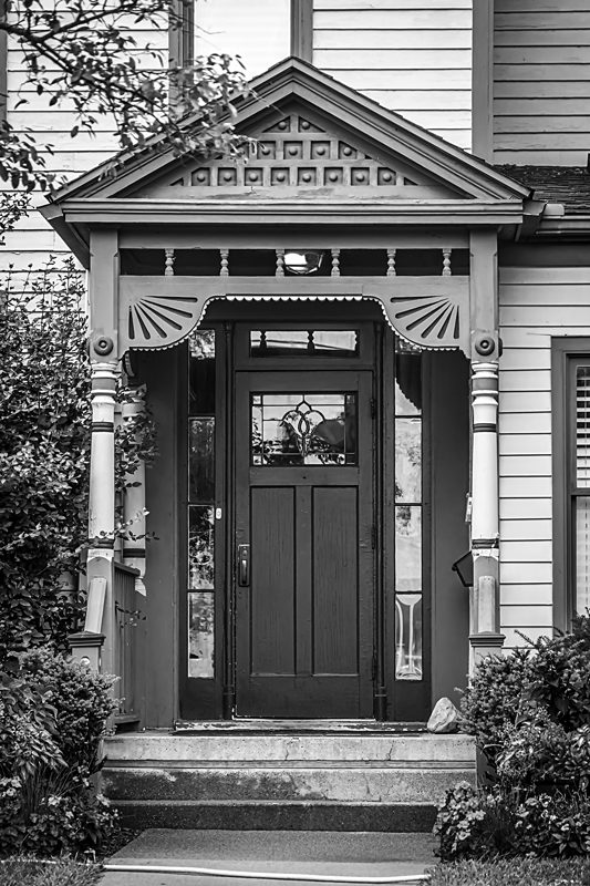 A black and white photo of a door.