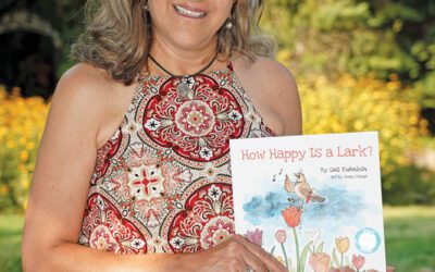 Gail Kuhnlein holding a copy of her book.