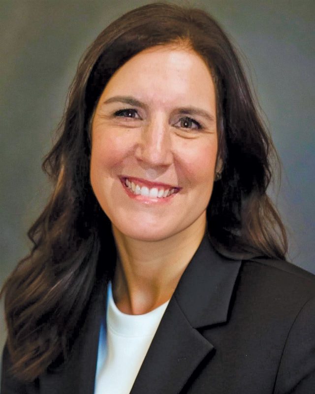 Tamara Garwood smiling and wearing a gray blazer.