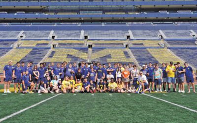 Football players and Best Buddies on a football field.