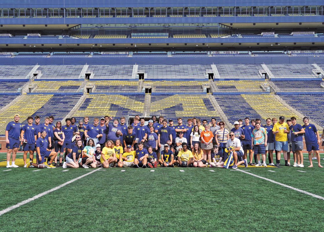 Football players and Best Buddies on a football field.