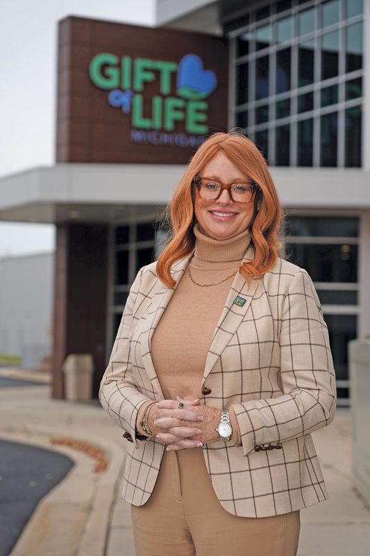 Dorrie Dils standing in front of the Gift of Life building. 