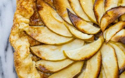 an overhead vie of an apple galette on a marble surface