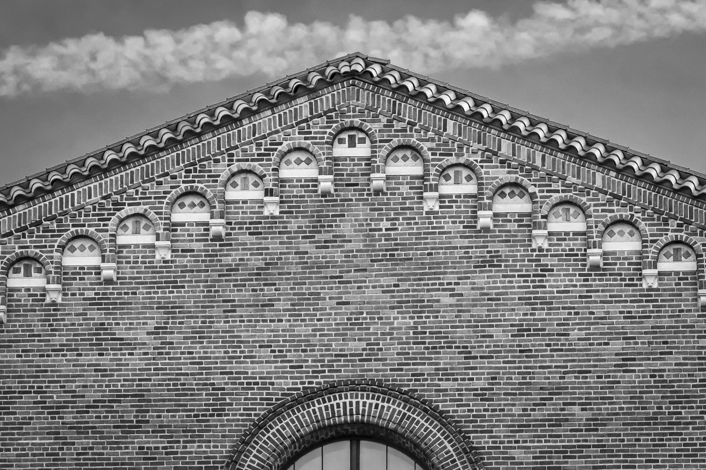 Black-and-white photo of the facade of a brick building