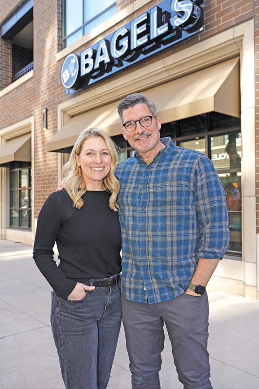 Ashley Dikos and Andrew Martinez standing in front of BO's Bagels.