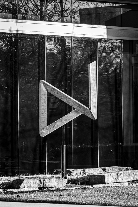 Black-and-white photo of a triangular sculpture.