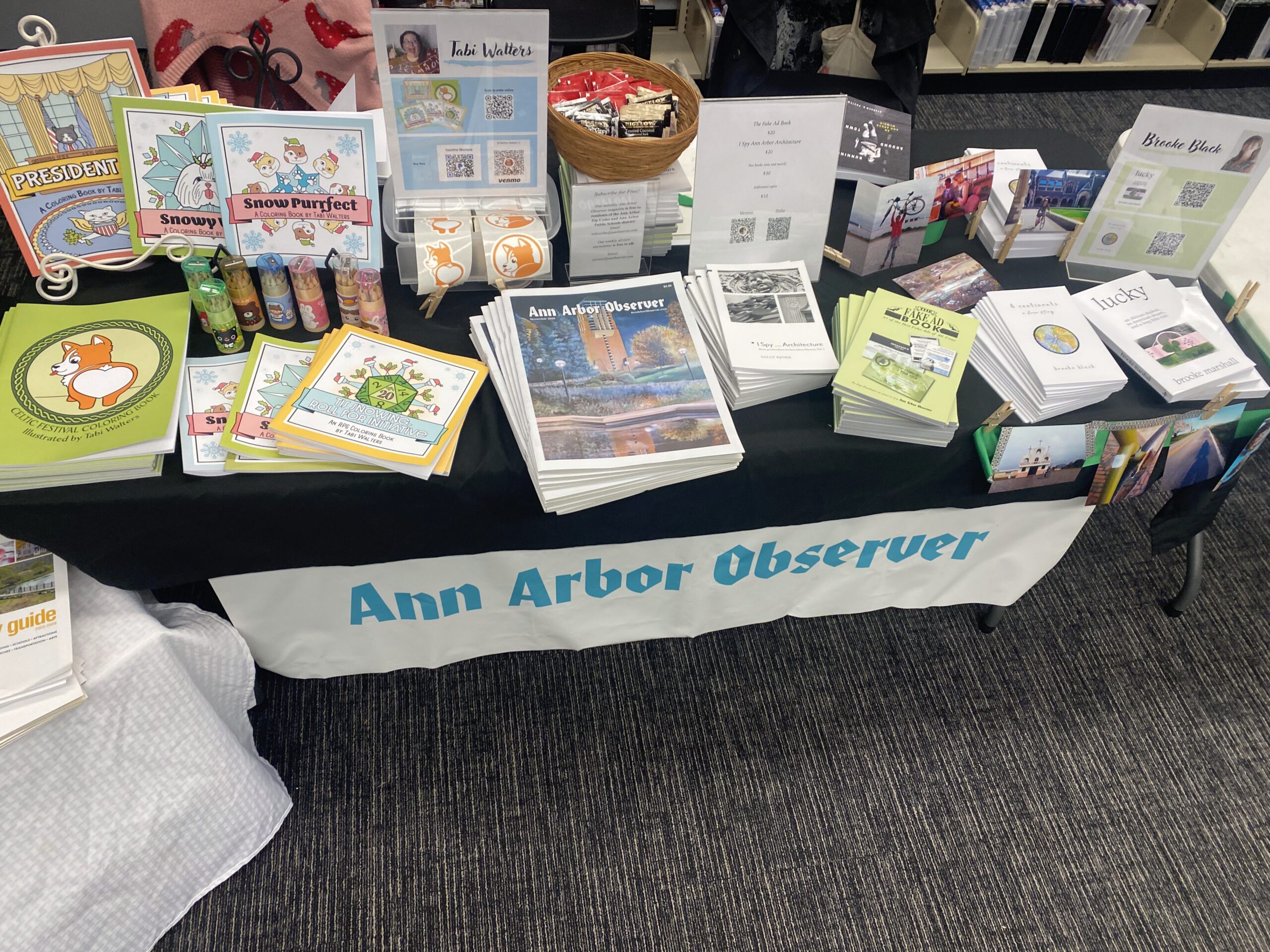 a stack of books and magazines on a table