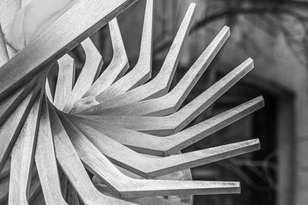 A metal sculpture of angular protrusions arranged in a spiral.