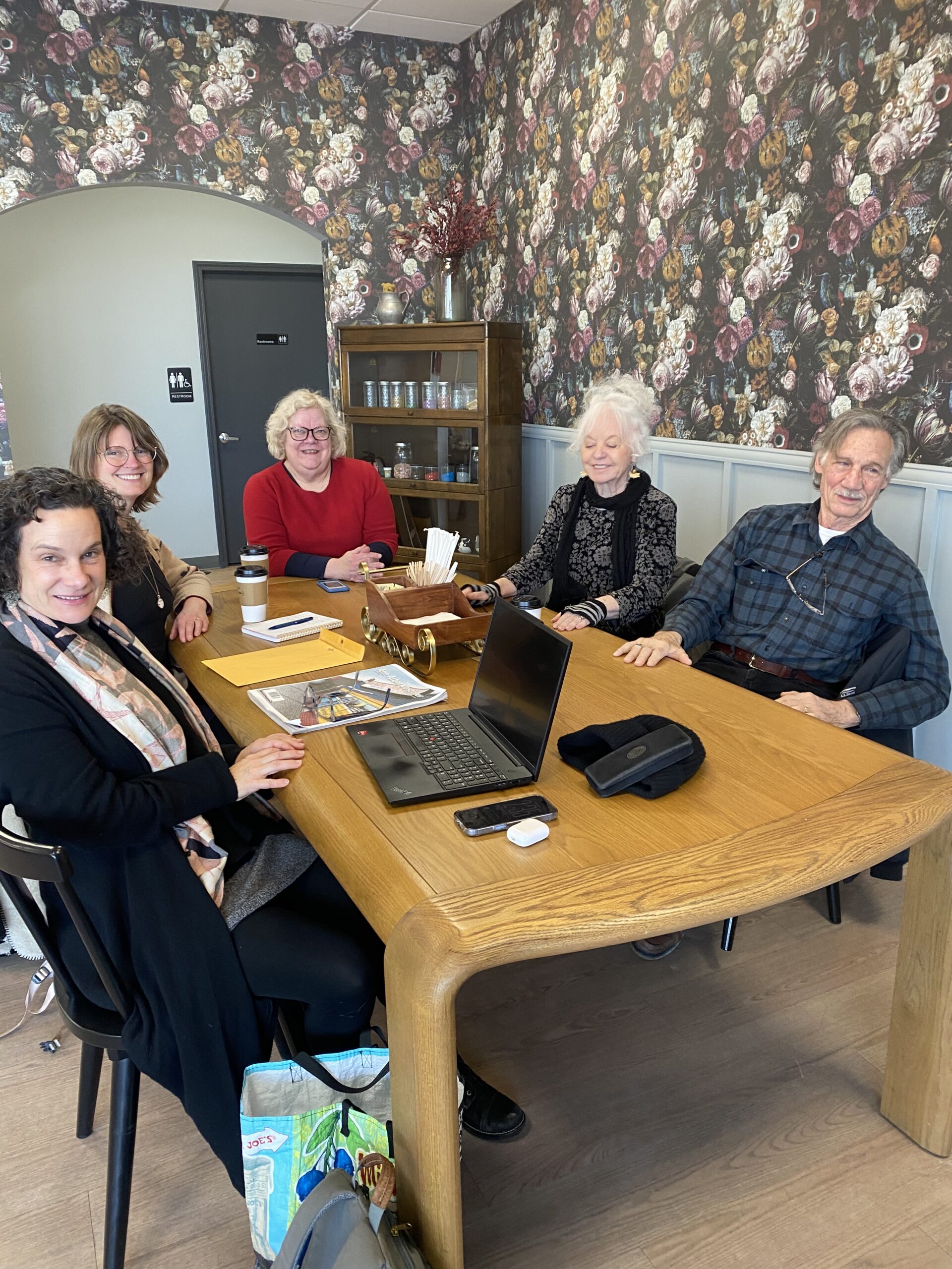 Five people sitting around a table. 