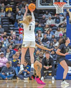 Olivia Olson shoots a basketball