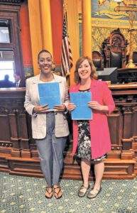 Representatives Morgan Foreman and Julie Rogers hold House Bill 4815 and House Bill 4814.