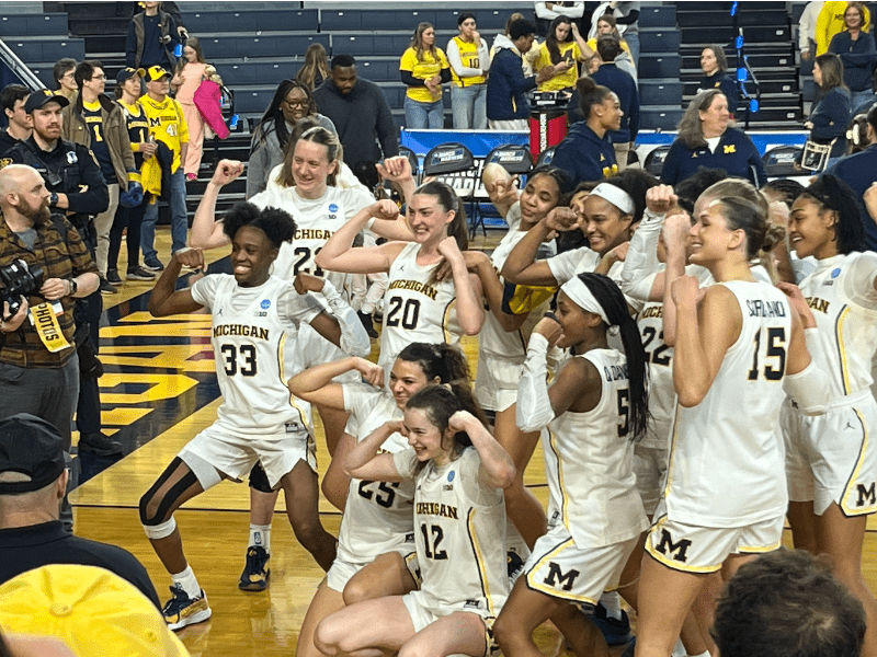 crowd of female basketball players celebrating