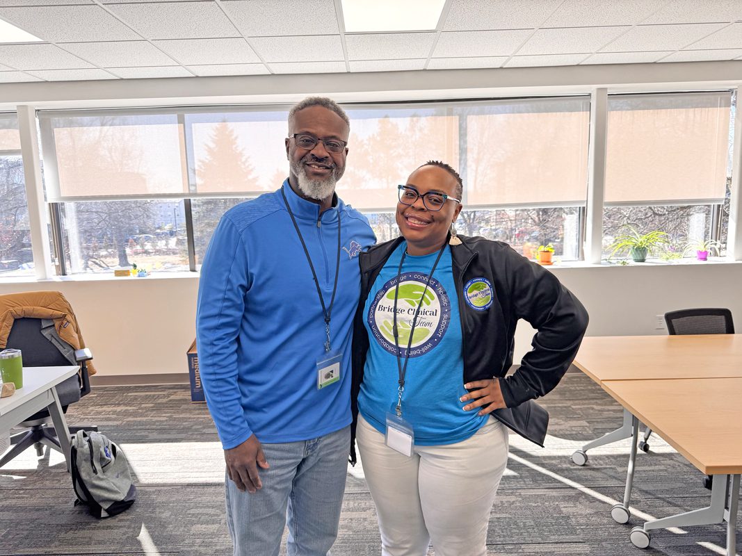 Jason Wesley and Chelsea Parker stand in a classroom.