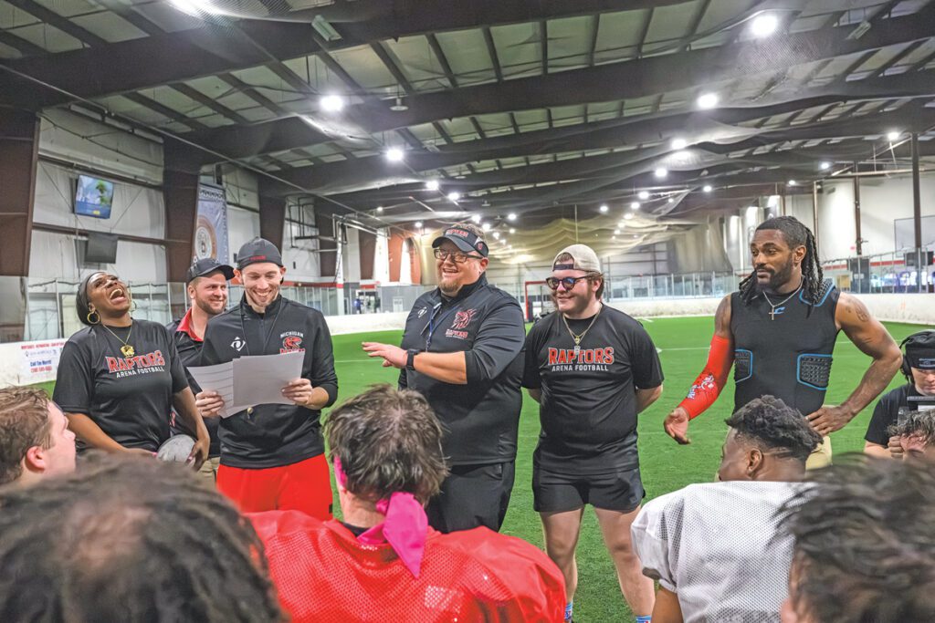 Michigan Raptors coaches giving a talk to the football players.