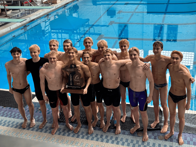a large group of shirtless young men holding a trophy in front of a swimming pool