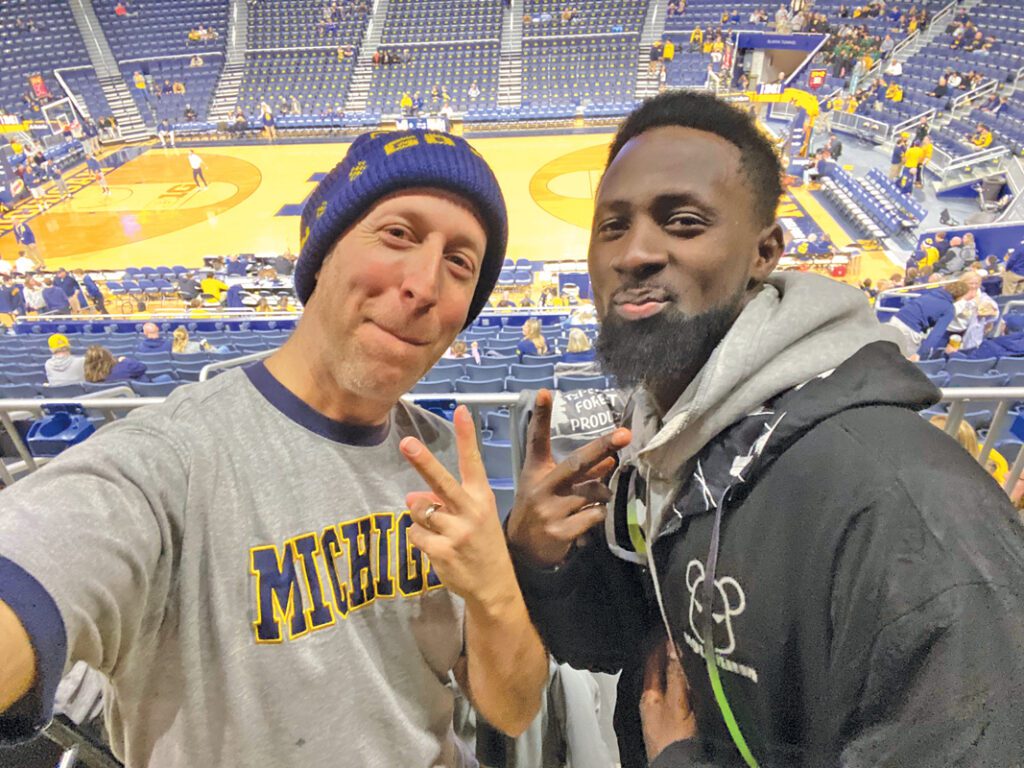 Davy Rothbart and Mamady Camara at a U-M basketball game