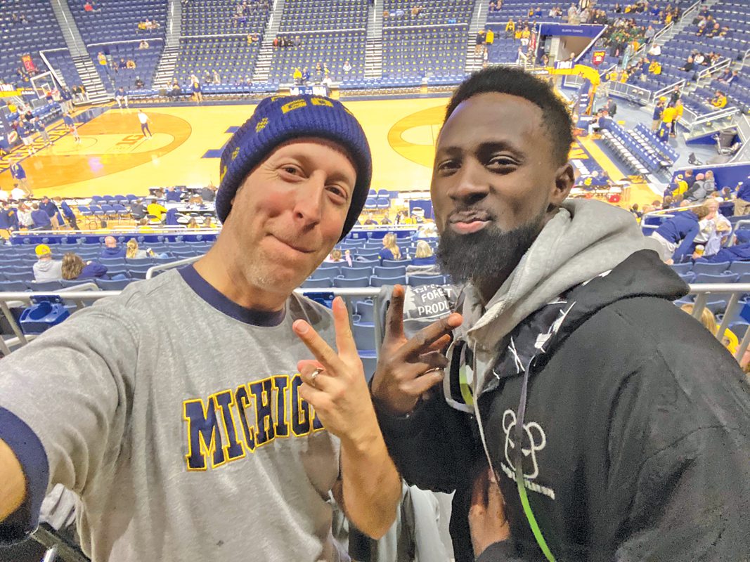 Davy Rothbart and Mamady Camara at a U-M basketball game