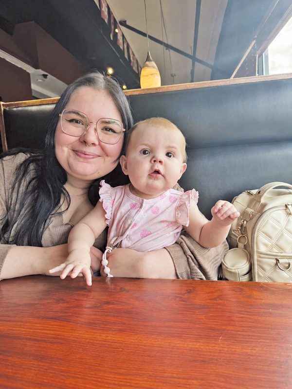 Haley Murphy smiles and holds her infant daughter