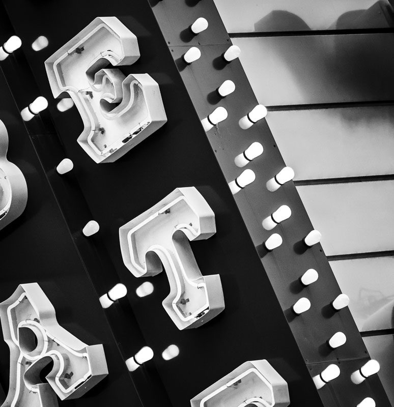 Black and white photo of a sign with the letters E, A, T.