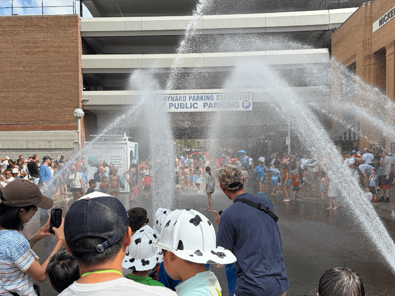 water spraying over crowds of revelers