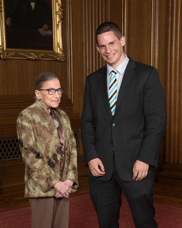 RBG stands next to Eli Savit.