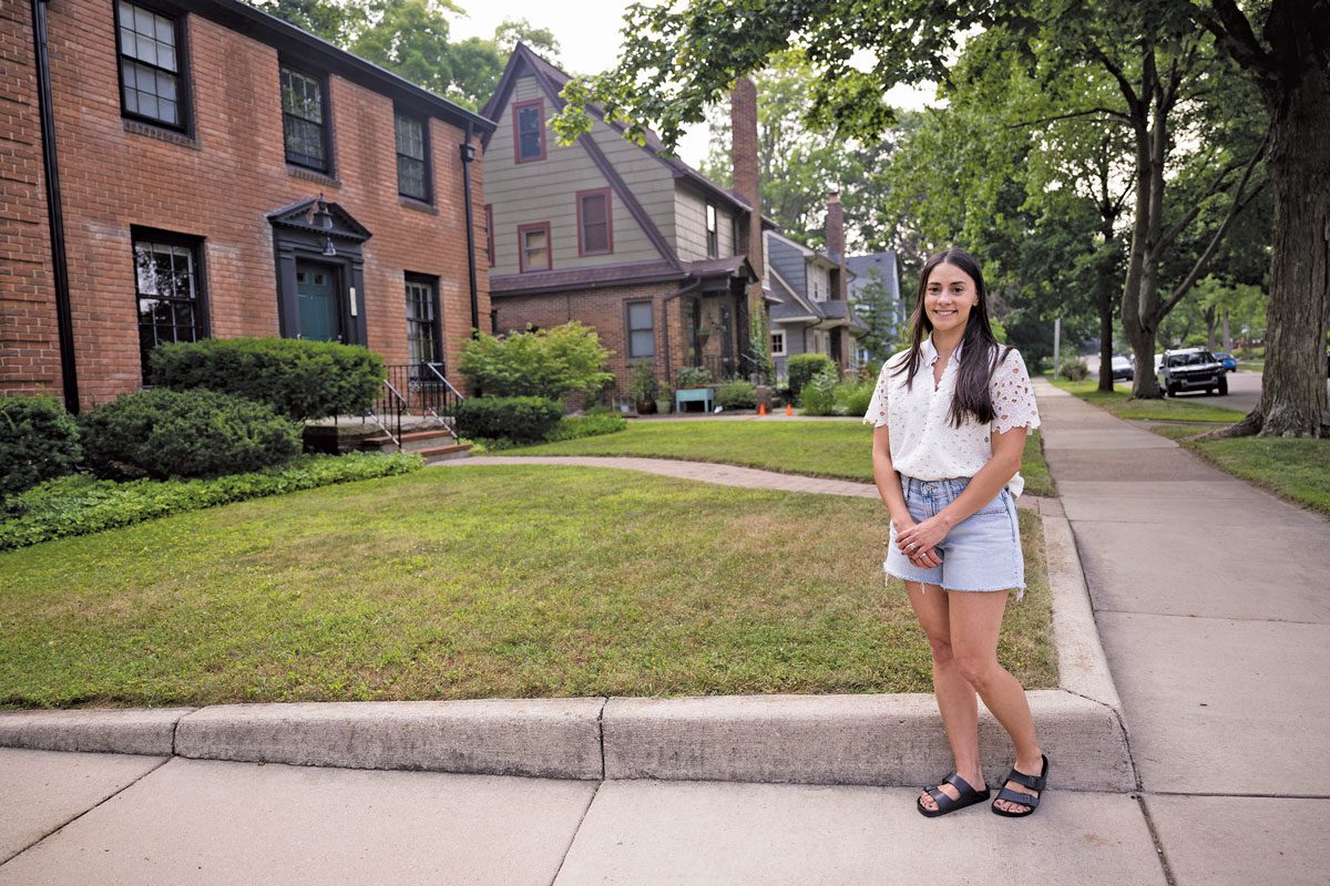 Lindsay Bryan-Podvin stands in a neighborhood of single-family homes. 