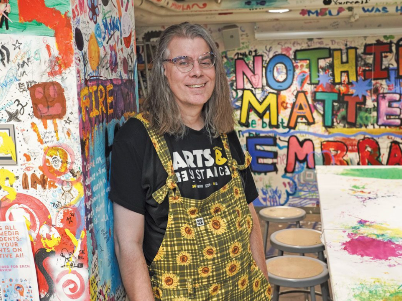 An artist surrounded by his work 