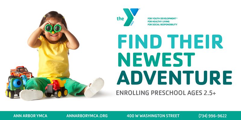 advertisement for Ann arbor YMCA. child playing with D I y binoculars and heading that reads find their newest adventure. interact with ad for more information