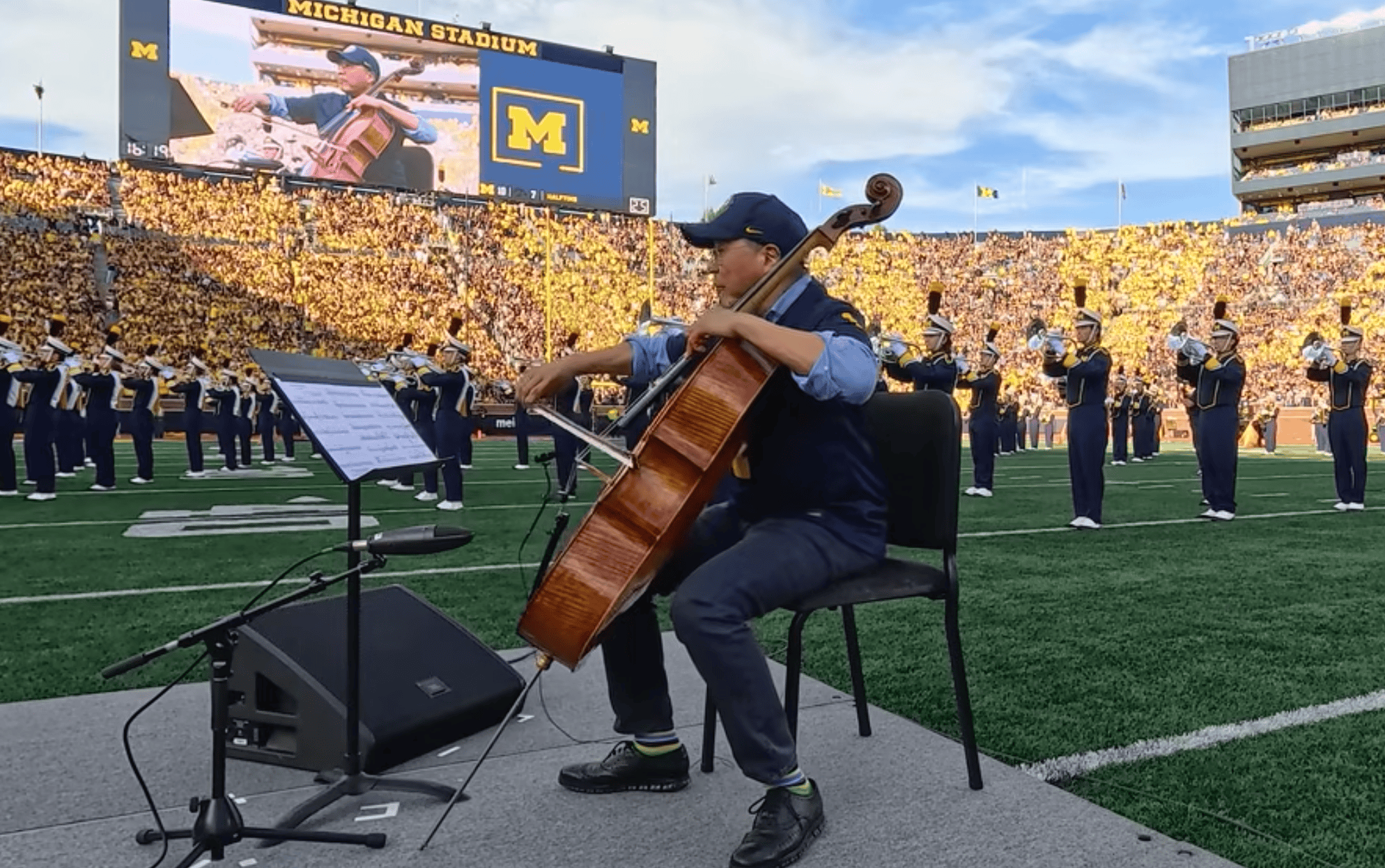Cellist playing at football game