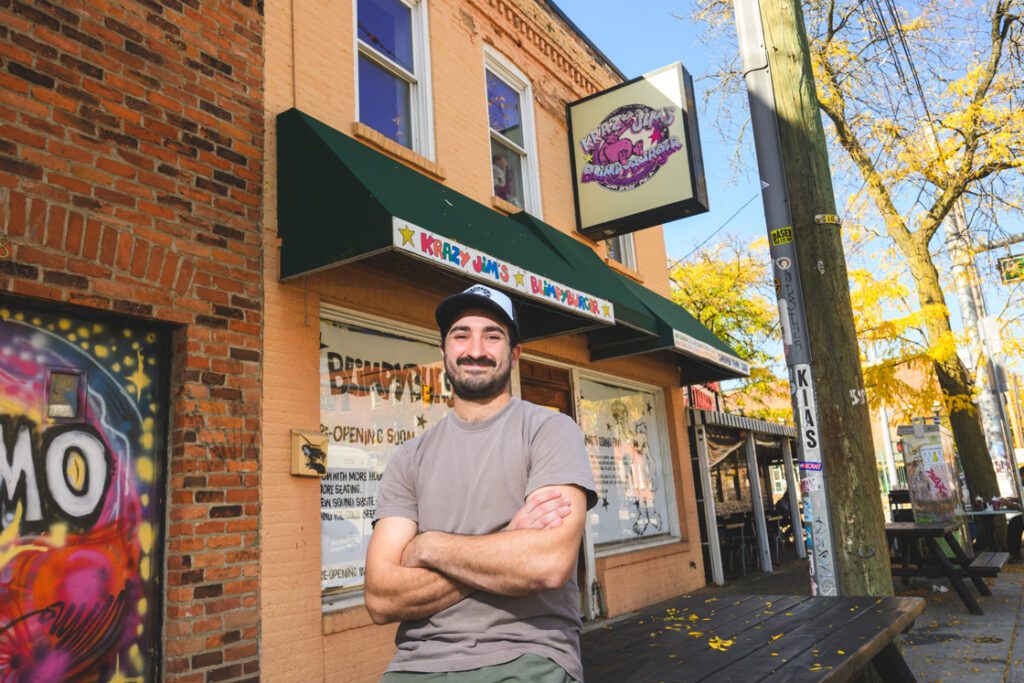 Doug Botsford stands outside the exterior of Blimpy Burger