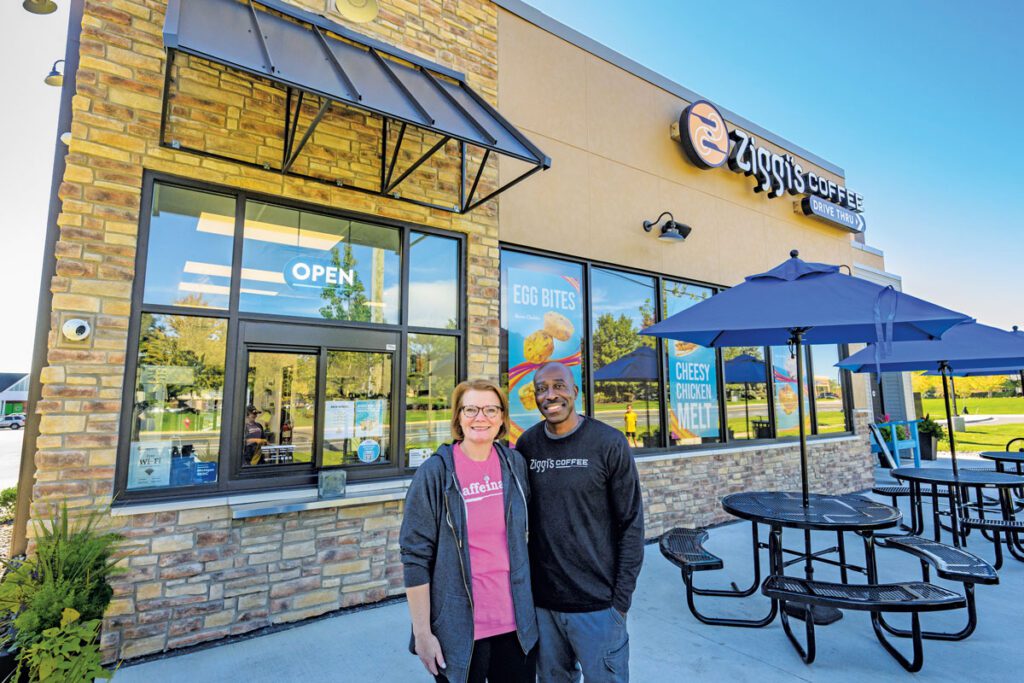 Miranda and Garnette Roberts stand in front of Ziggi's Coffee.