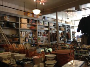 Interior of Downtown Home & Garden with picnic baskets, spoons, and bowls.