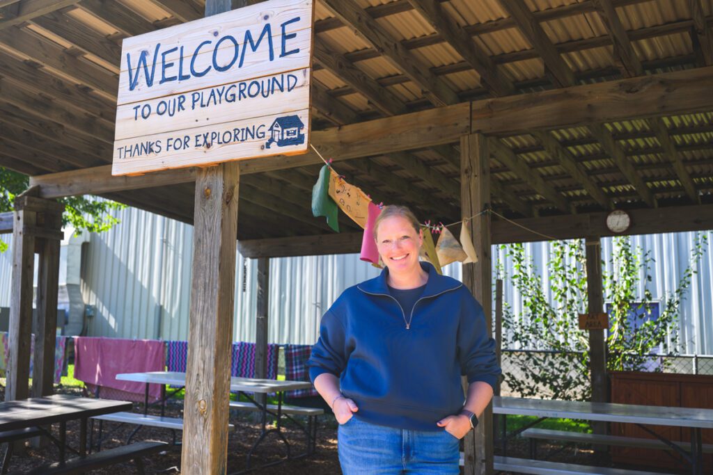 Stephanie Lingo stands in front of a playground at a Gretchen's House child care center.